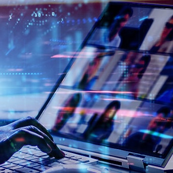 Laptop with a webinar on the screen.